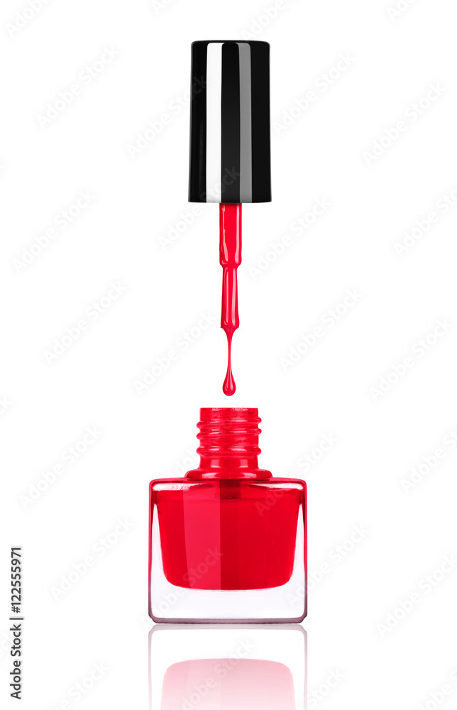 Nail polish dripping from brush into bottle on white background