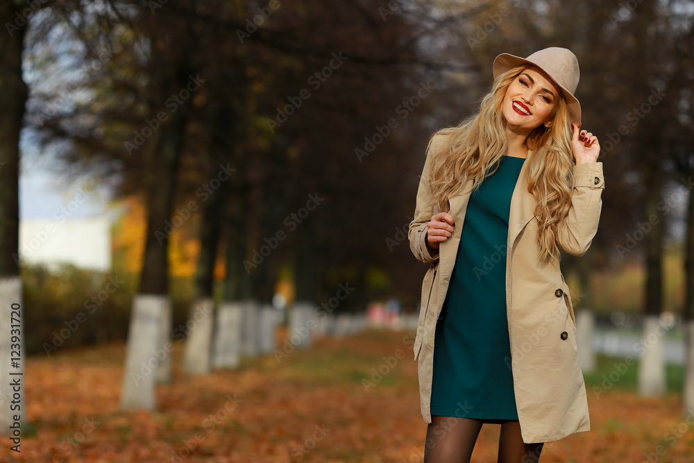 Beautiful woman smiling in autumn park.