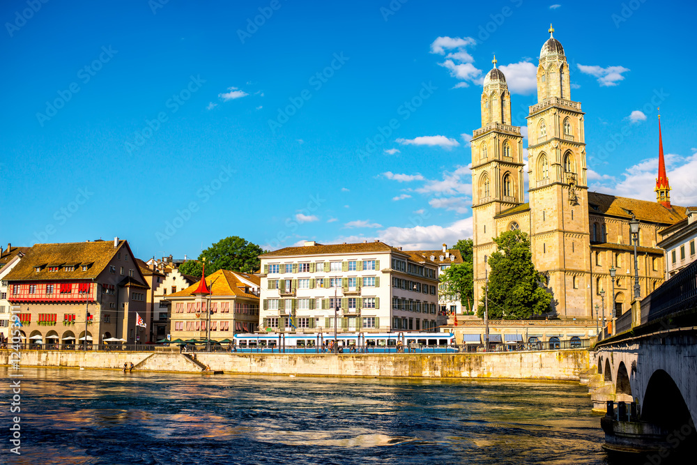 View on the riverside with beautiful buildings and Great Minster Church in Zurich city in Switzerlan