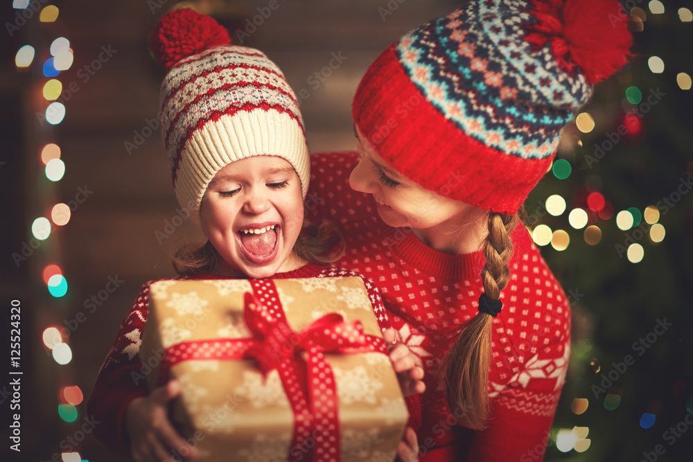 Happy family mother and child girl  with Christmas present