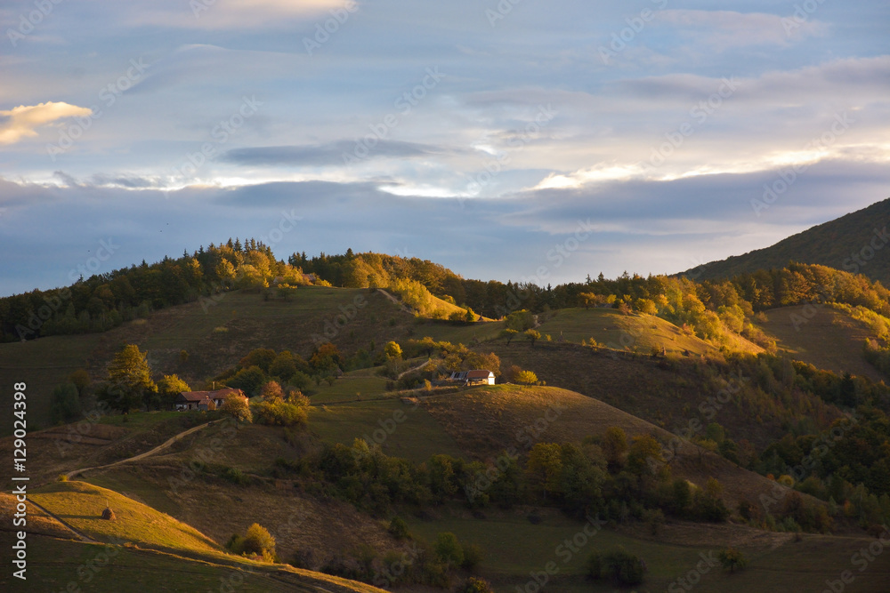 Evening sunset on mountain hills of Simon village. Bran.