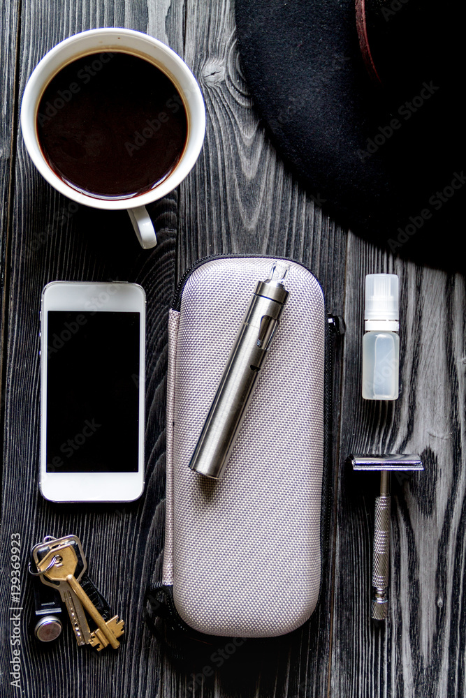 coffee, electronic cigarette, mens accessories dark wooden background top view