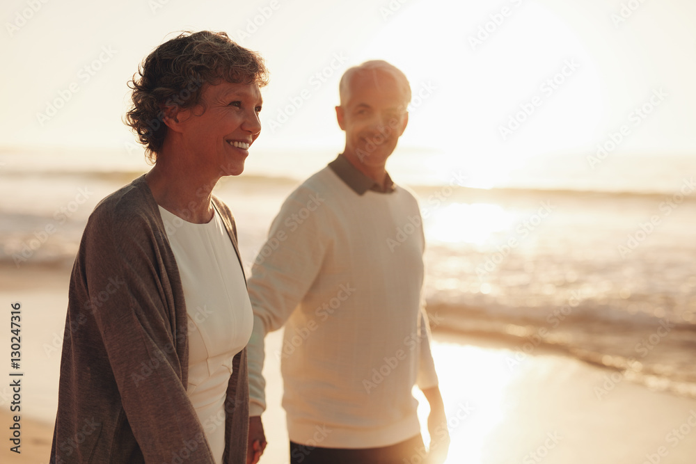 Senior couple walking along the sea shore