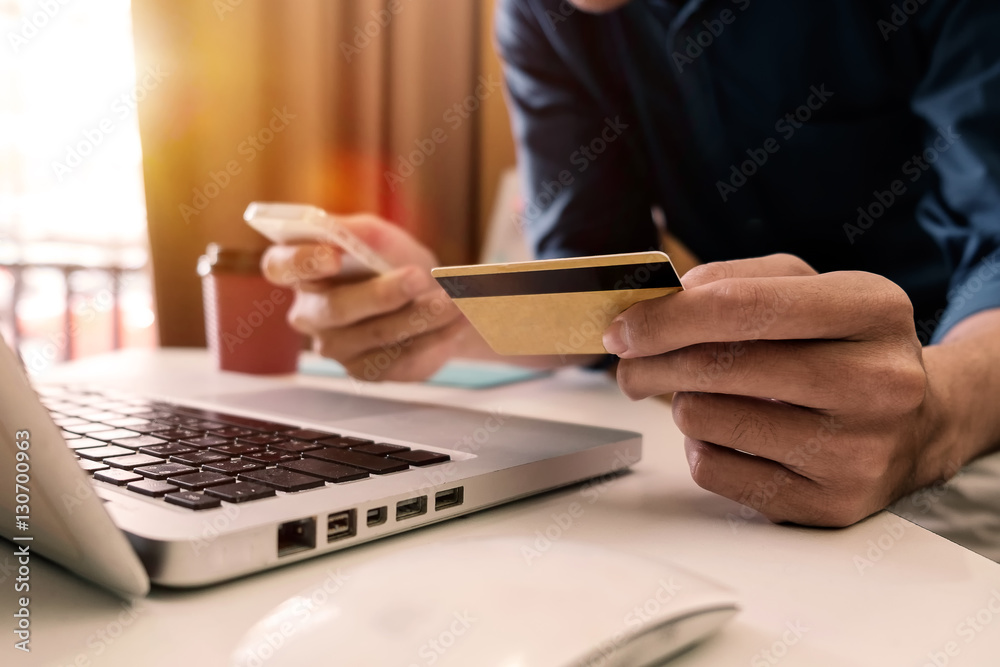 Man hands using smartphone laptop and holding credit card with social media as Online shopping conce