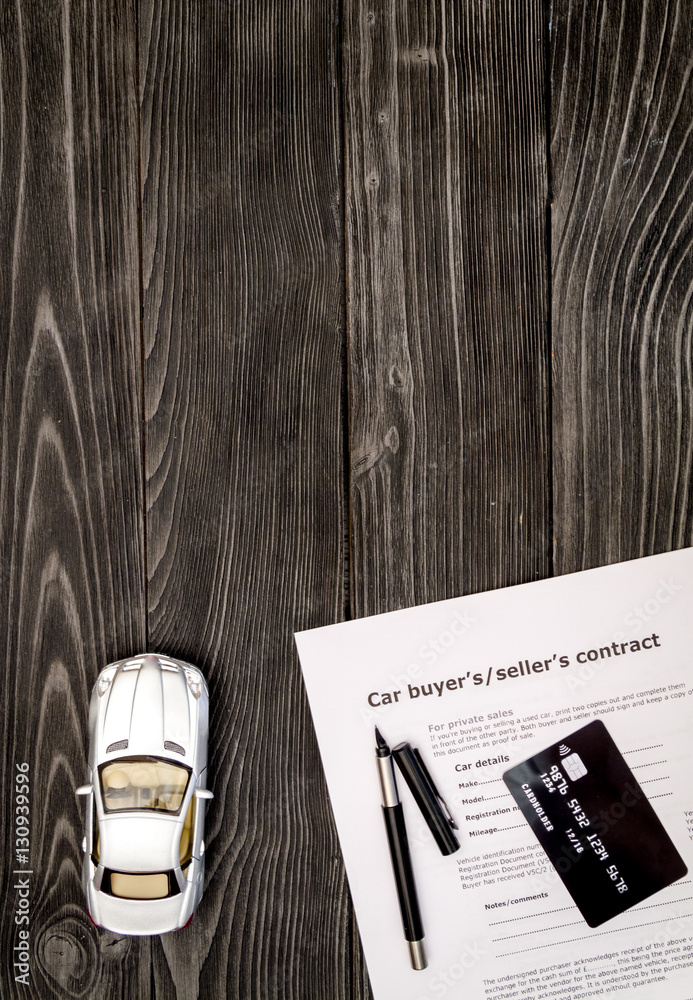 concept of buying car on dark wooden background top view