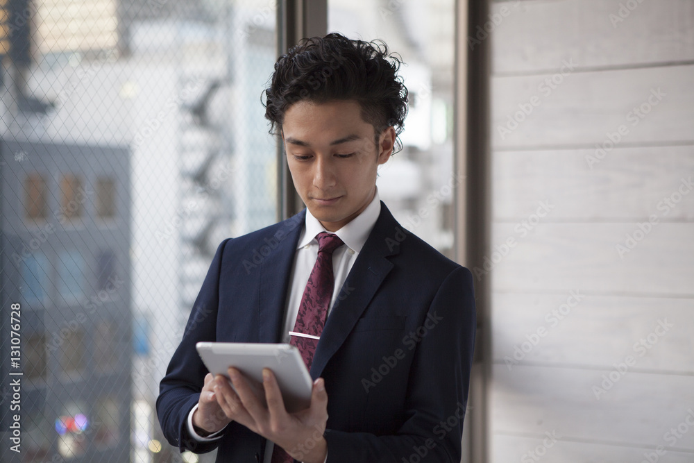 Businessman is using an electronic tablet