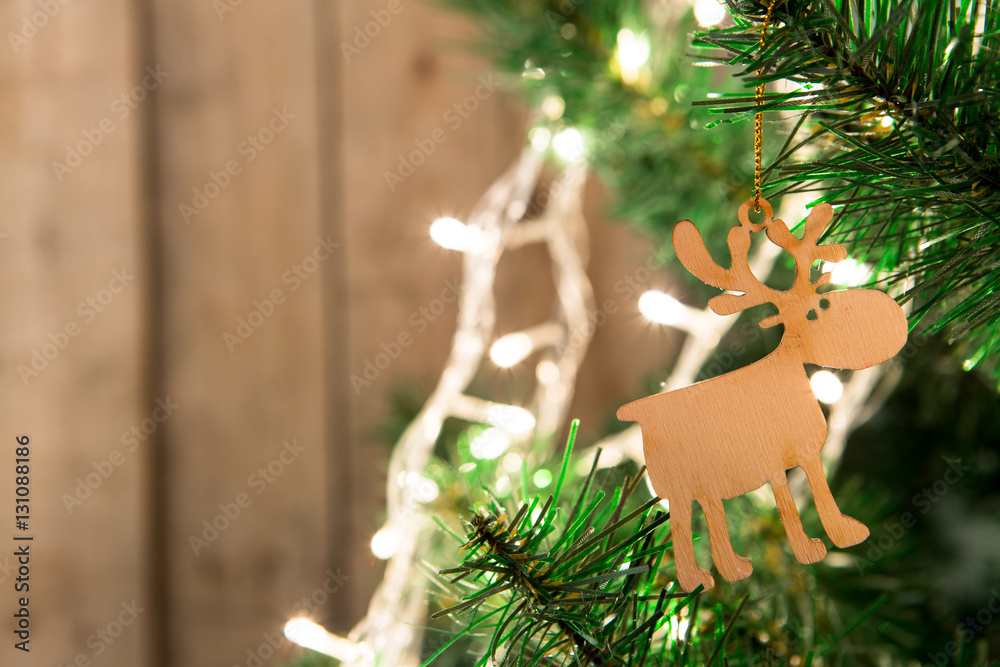 Christmas tree with lights on the wooden background