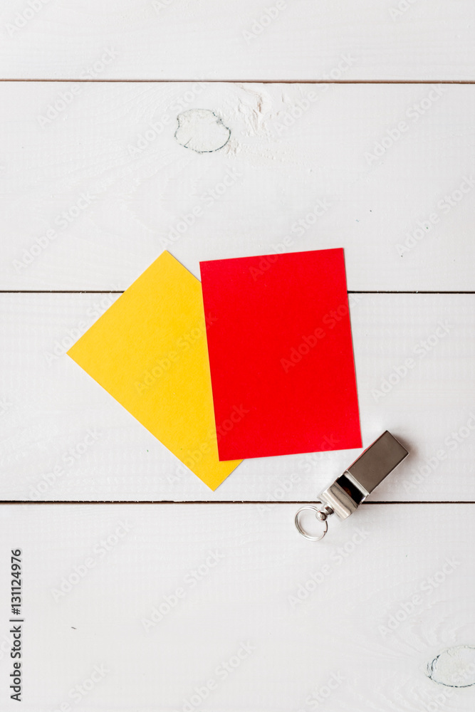 red and yellow cards on wooden background top view