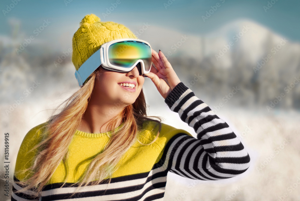 happy girl in a mask for snowboarding against the backdrop of sn