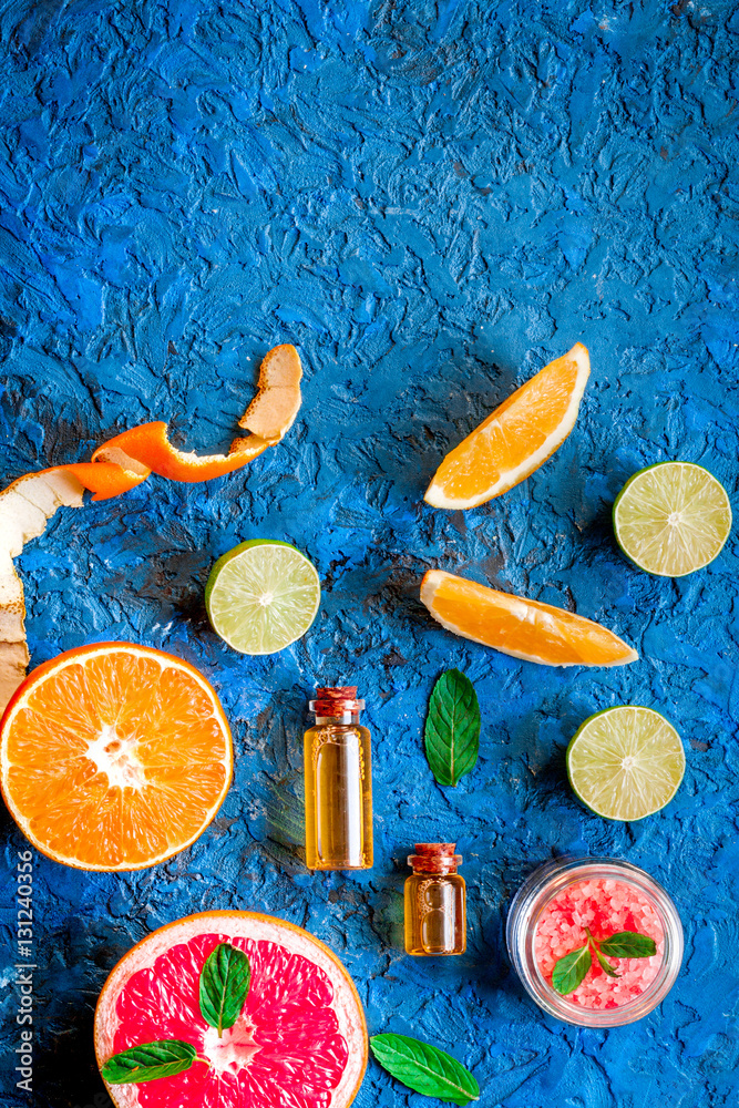 organic cosmetic with citrus on blue background top view