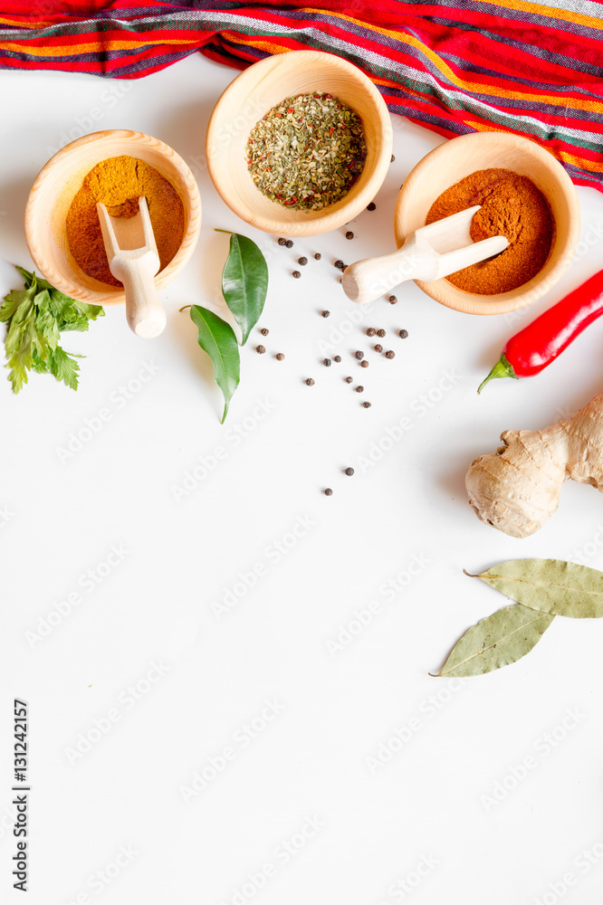 spices in wooden spoons white background top view mock up