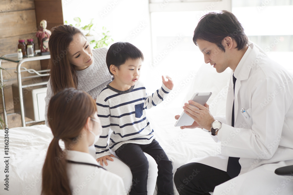 The doctor explains it while showing the tablet to parent and child