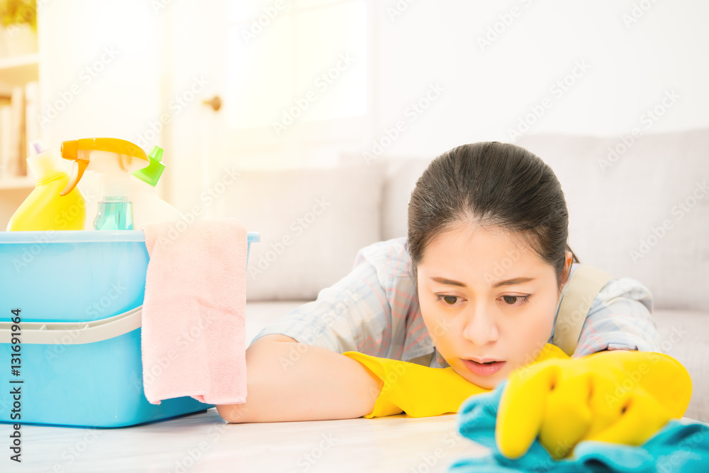 Tired woman holding rab with detergents