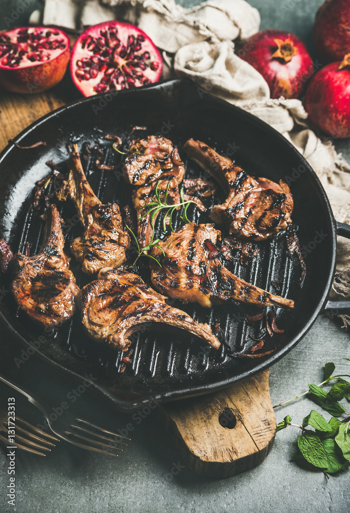 Barbecue dinner. Grilled lamb meat chops with onion and rosemary in cast iron pan served with fresh 