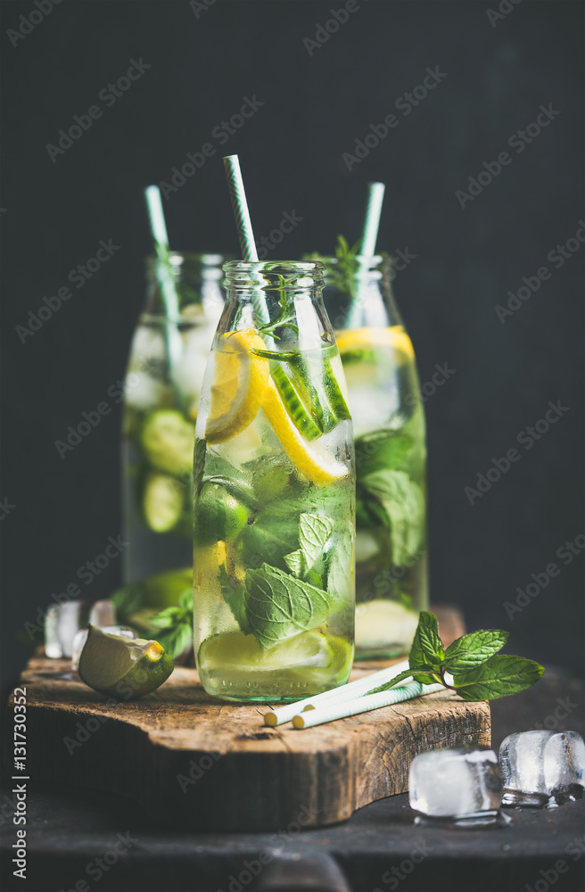 Citrus fruit and herbs infused sassi water for detox, healthy eating or dieting in glass bottles wit