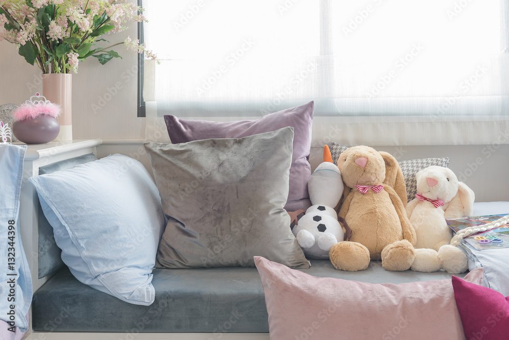 kids bedroom with dolls and set of pillows