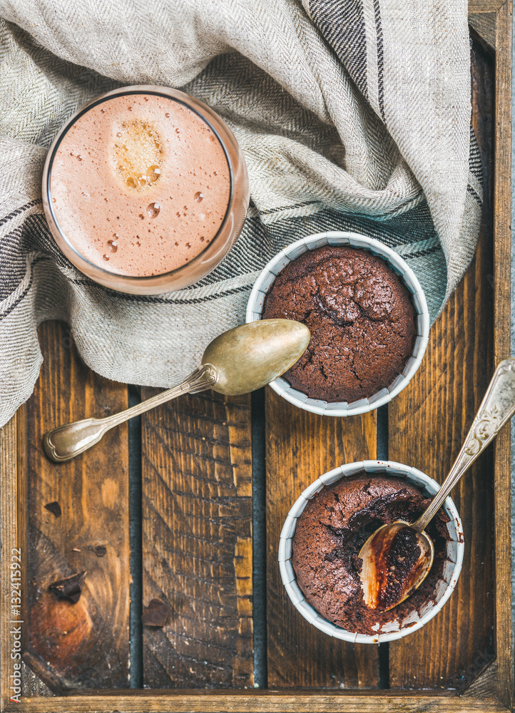 Chocolate souffle in individual baking cups and chocolate mocha coffee in wooden serving tray, top v