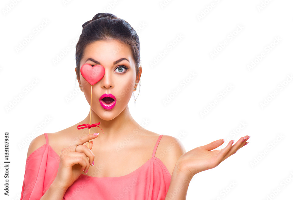 Valentines Day. Beauty surprised young fashion model girl with Valentine heart shaped cookie