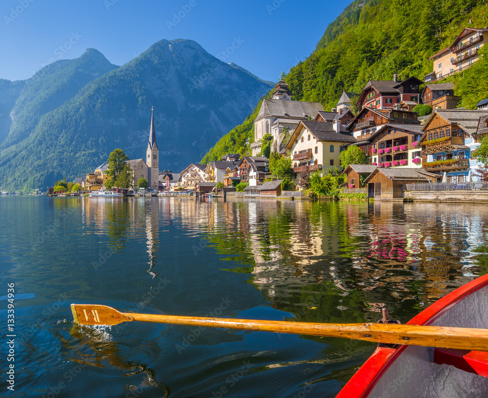 Classic view of Hallstatt with traditional rowing boat in summer, Salzkammergut region, Austria