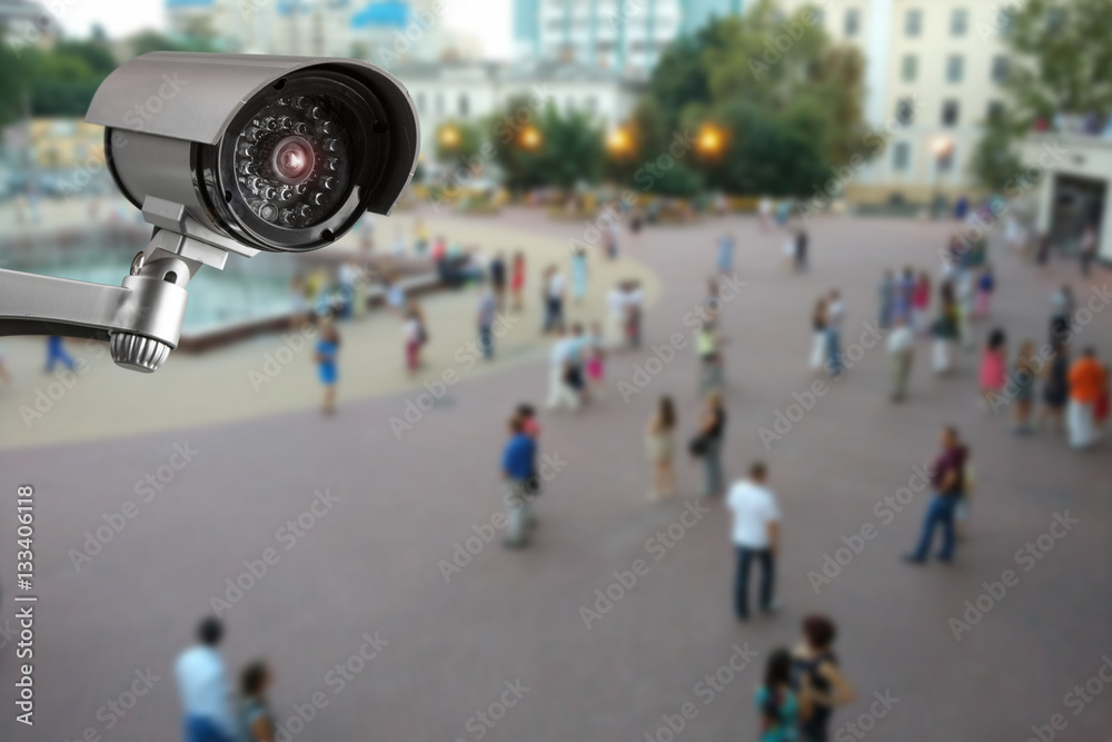Security camera, blurry street with people on the background