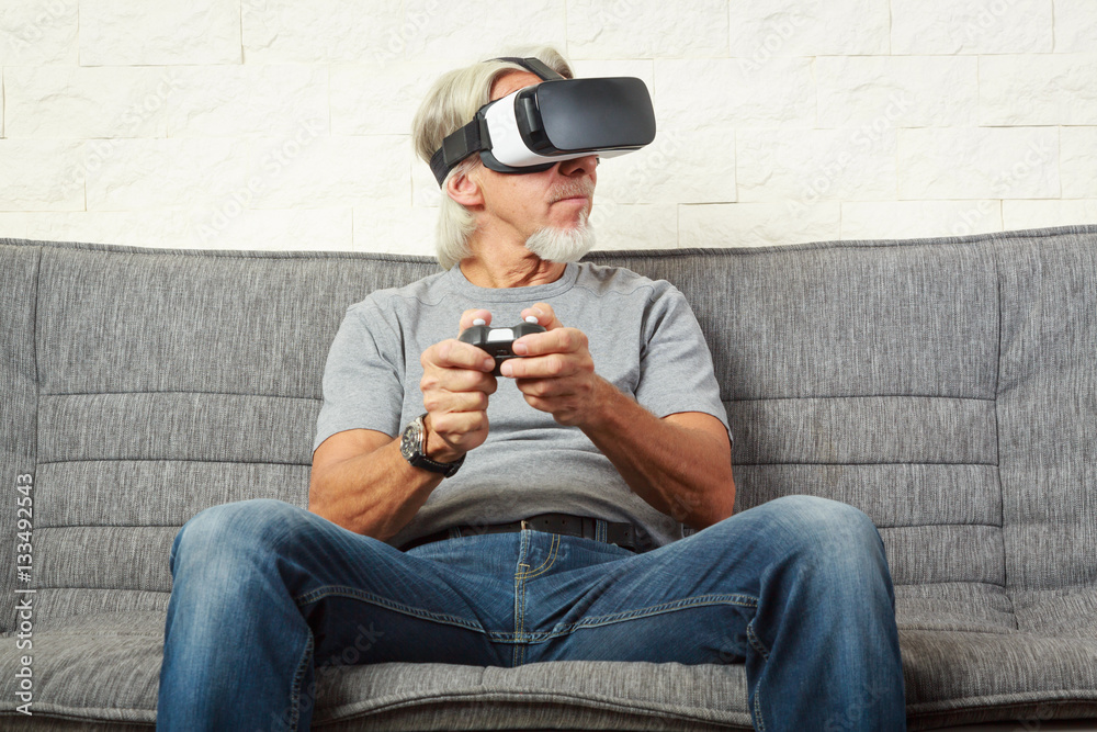 Senior Man On Couch, Playing A Vr Game