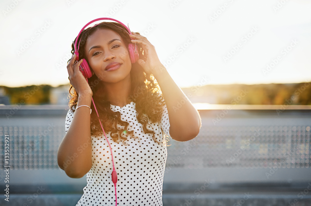 Black woman listening to her headphones
