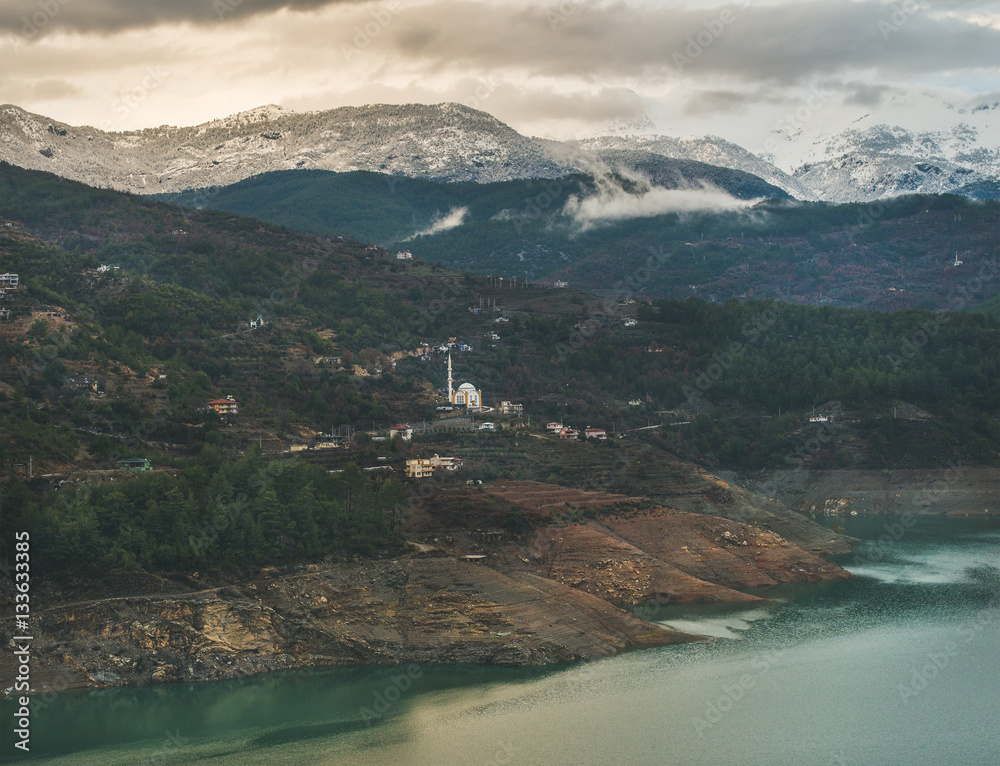 Dim Cay storage pond and mountains covered with snow in Alanya, Southern Turkey