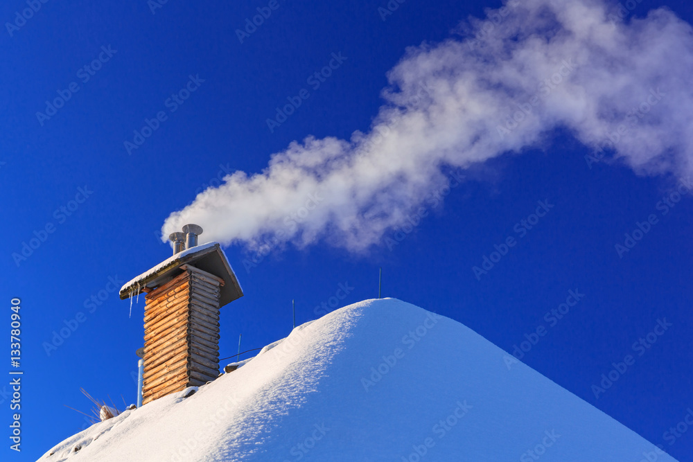 Chimney of the house at winter season with ecological gas smoke