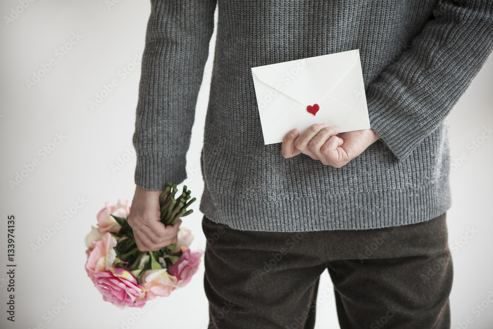 Men hide cute bouquets and letters behind