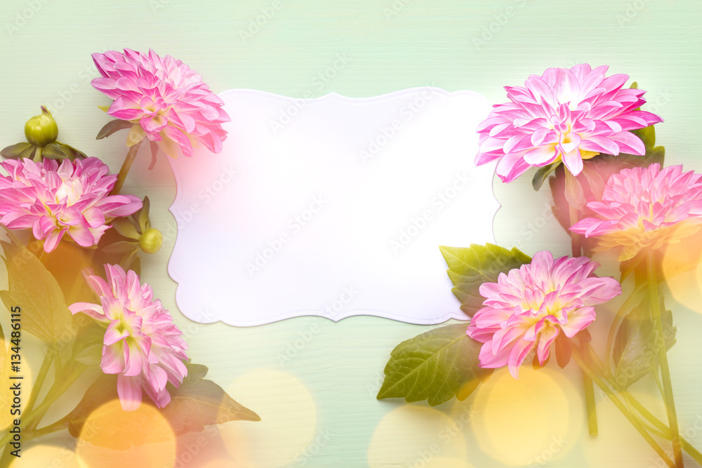 Pink dahlia flower with blank card