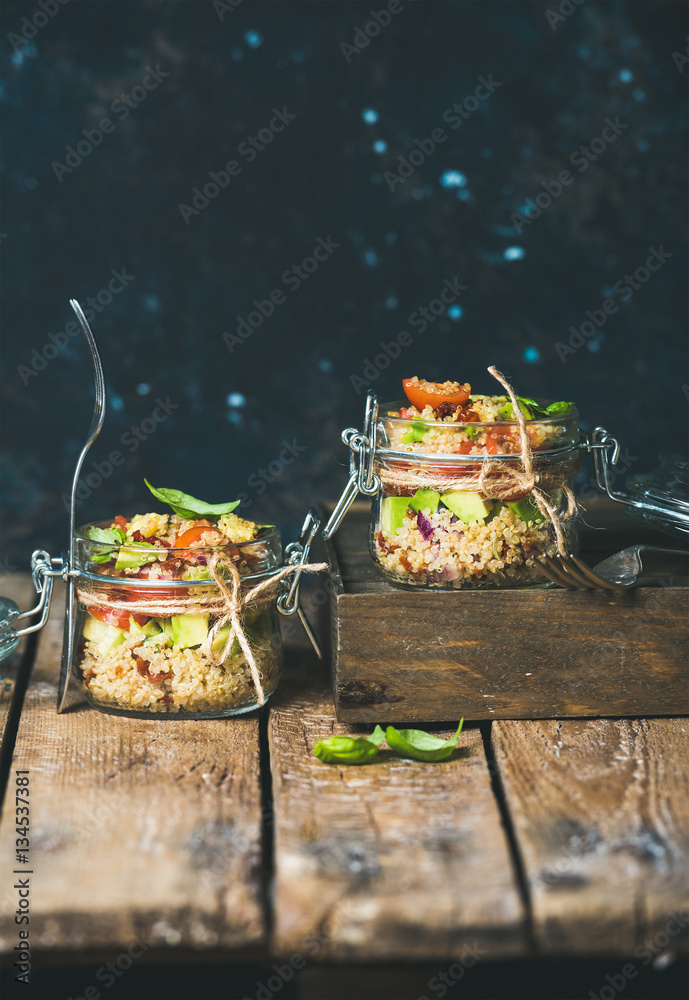 Homemade jar quinoa salad with cherry tomatoes, sun-dried tomatoes, avocado and basil. Detox, dietin