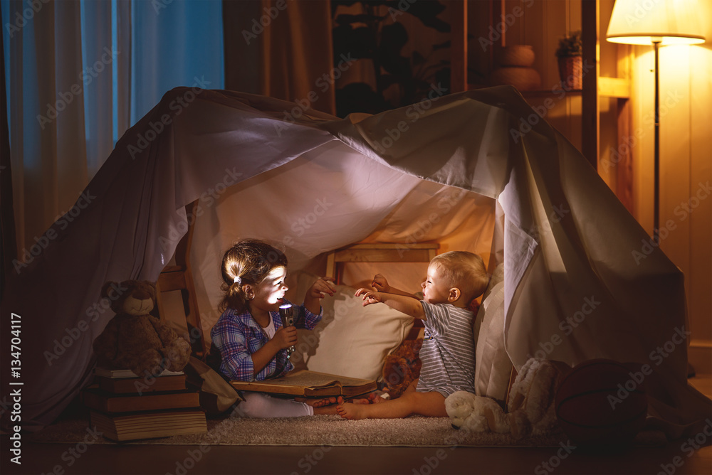 children boy and girl playing and frighten each other in  tent