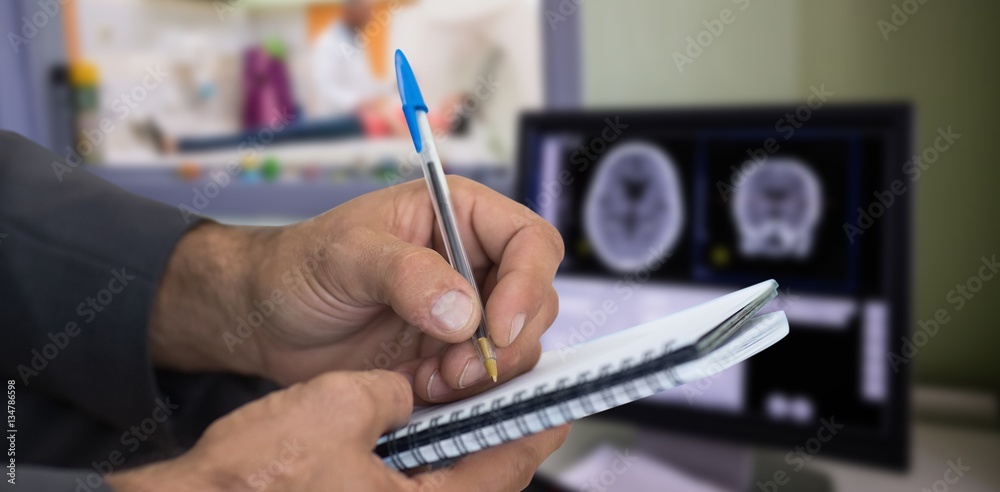Composite image of close up of man writing in spiral book