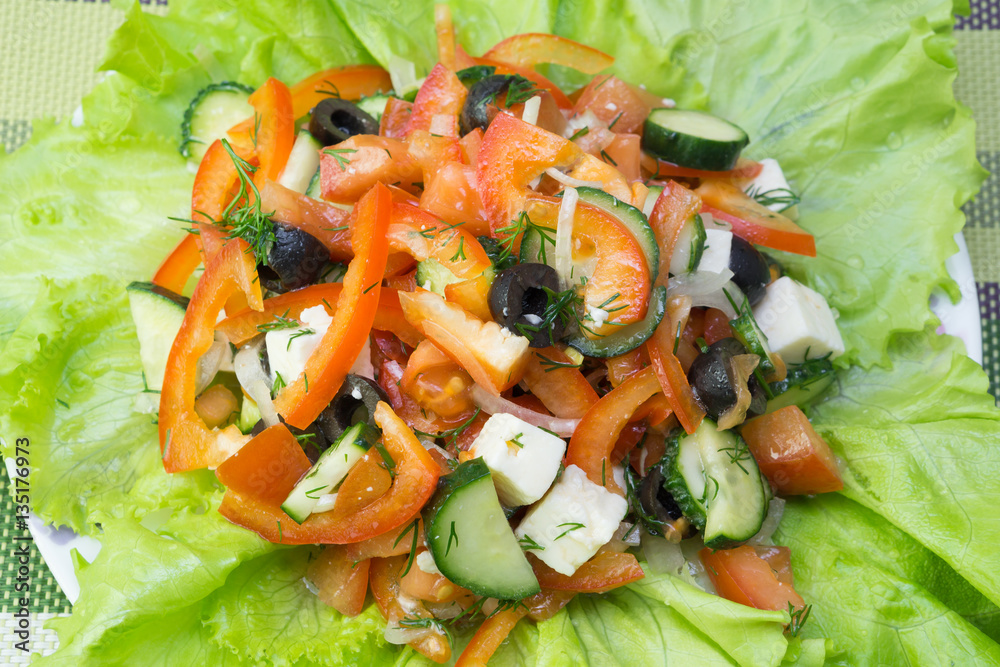Vegetarian salad with fresh vegetables and cheese. Paprika, olives, cucumber.