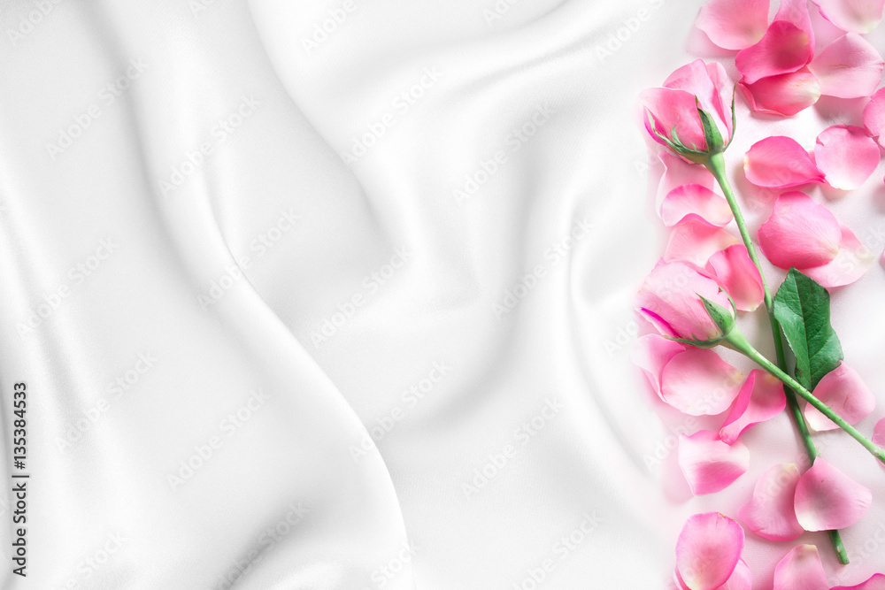  a bouquet sweet pink roses  petal on  soft white silk fabric ,