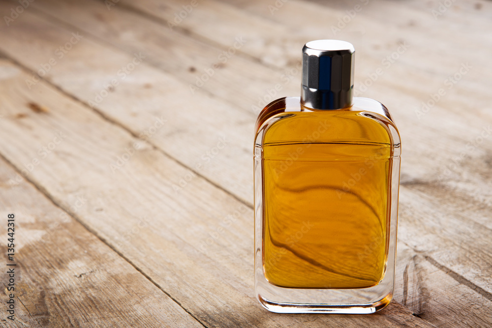 perfume bottle on the wooden background