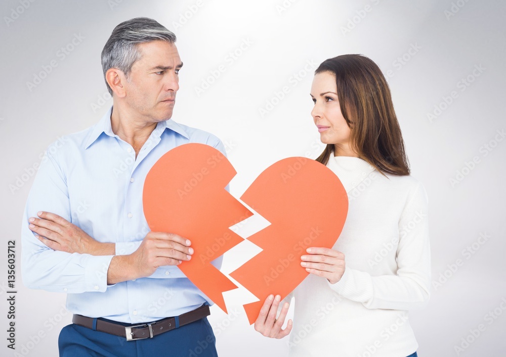 Mature couple holding a broken heart