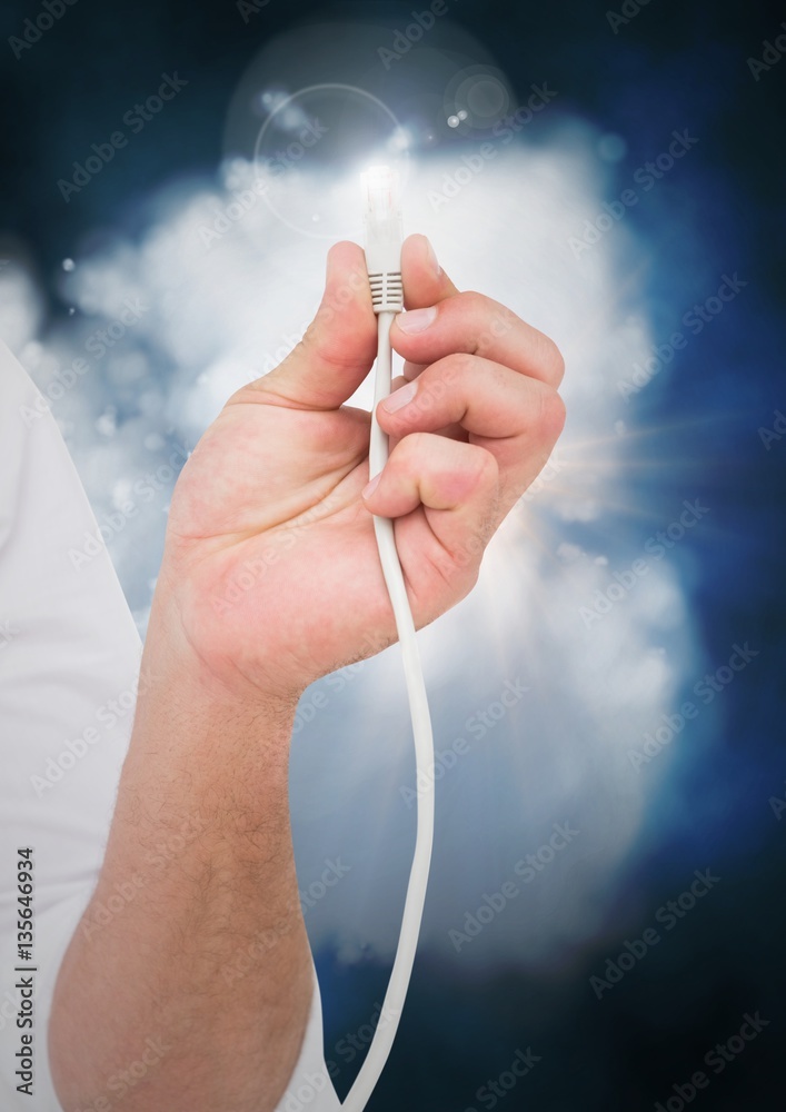 Man hand with cable and flare against digitally generated cloud
