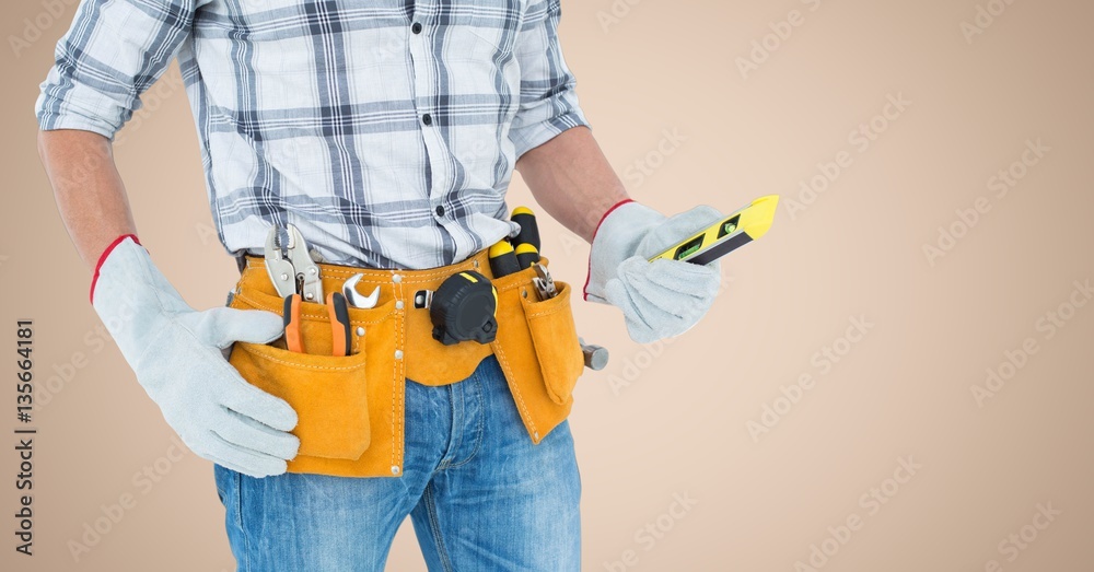 Mid-section of handy man with tool belt