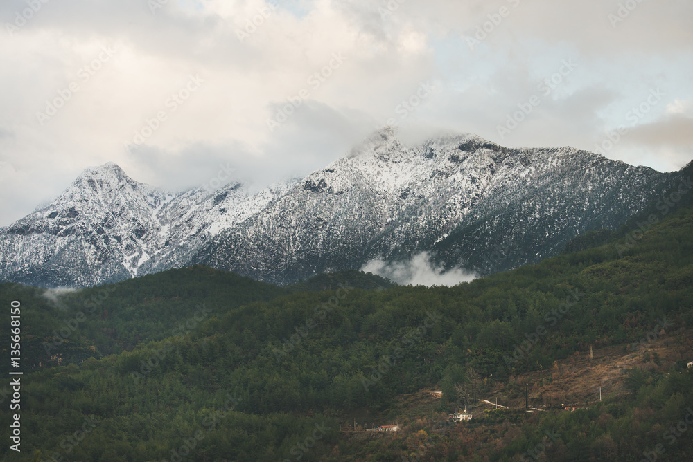 Green slopes of the Taurus mountains covered with snow in winter. Southern Turkey, Alanya, Dim Cay r