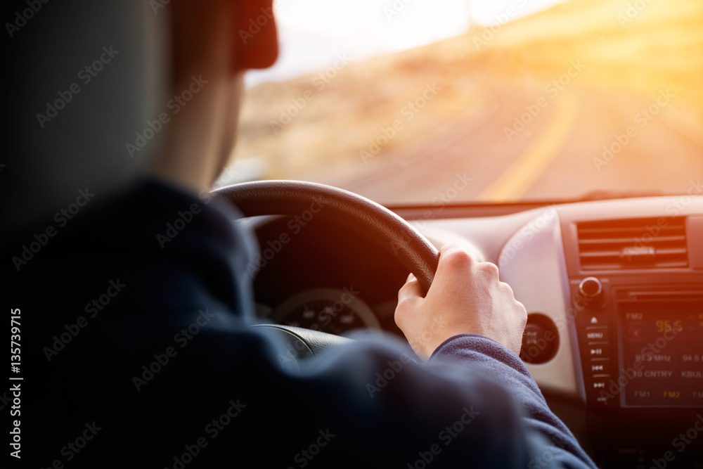 Driving car hands on steering wheel