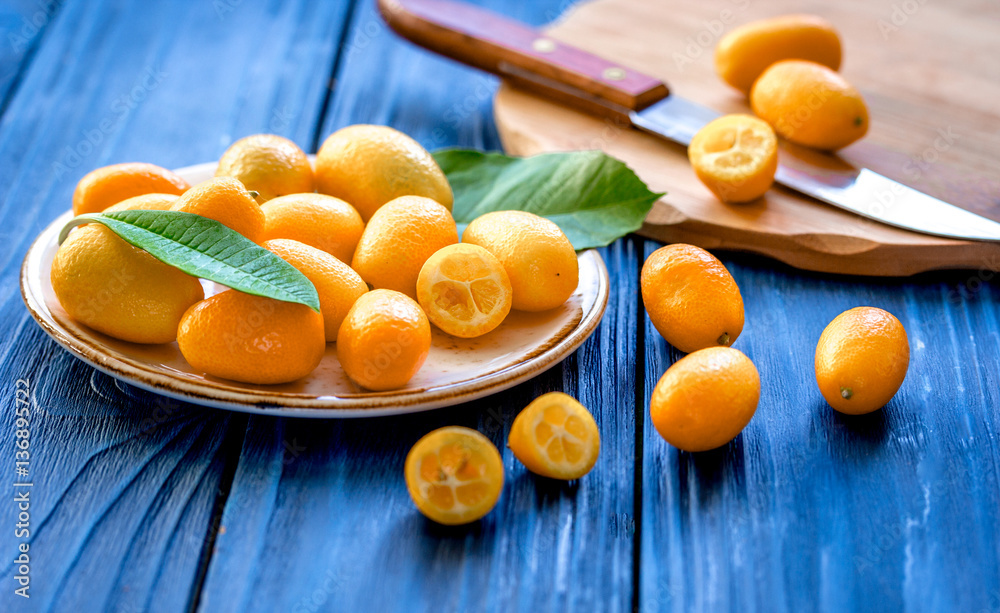 kumquat on plate at wooden table