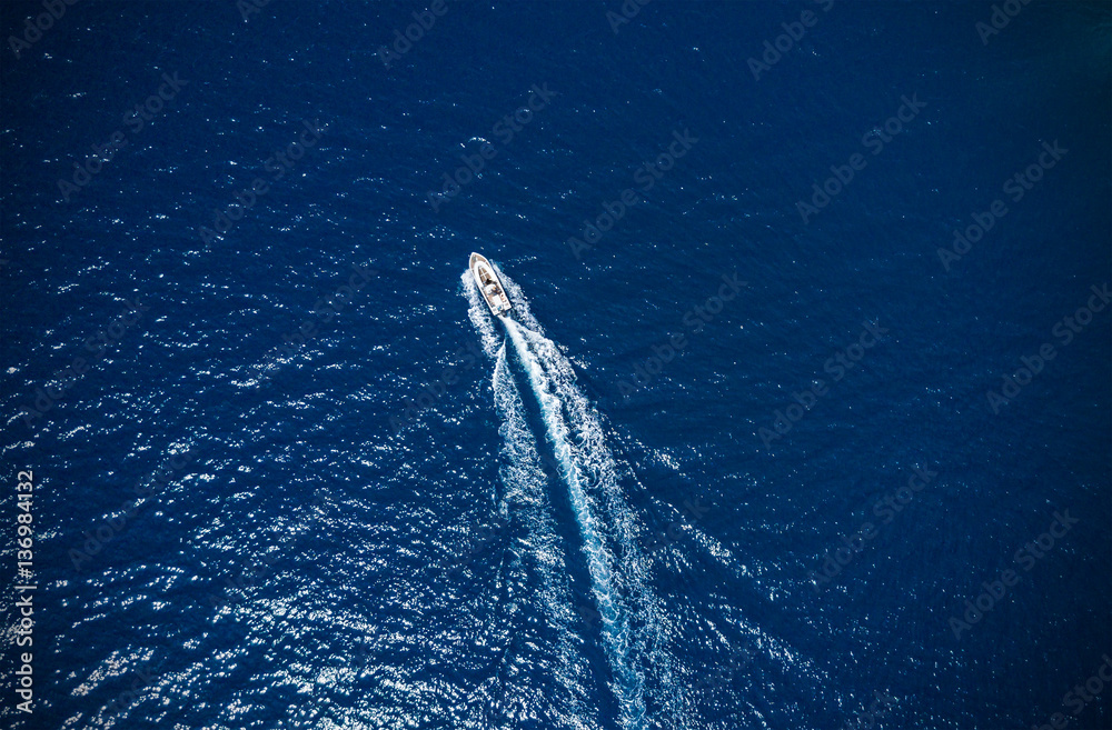 Aerial view of small boat flowing in sea