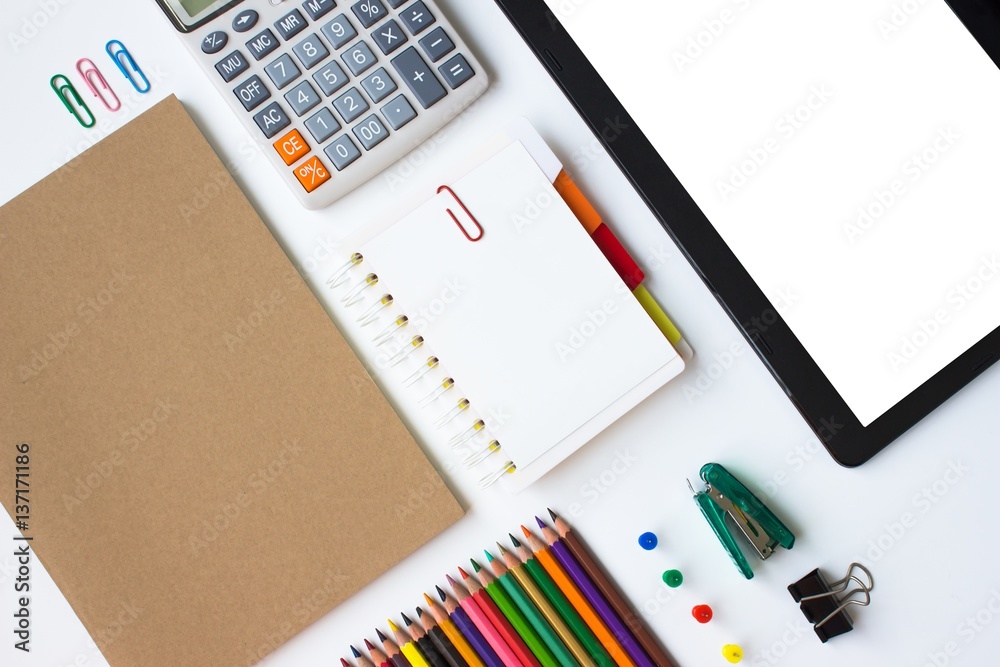 paper blank and paper note, color pencil, calculator, smartphone, pen on white desk with copyspace /