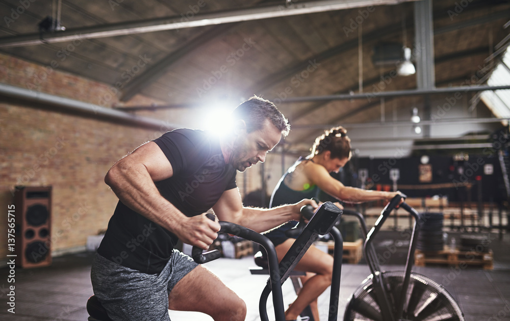 Sportsmen working out hard on cycling machines