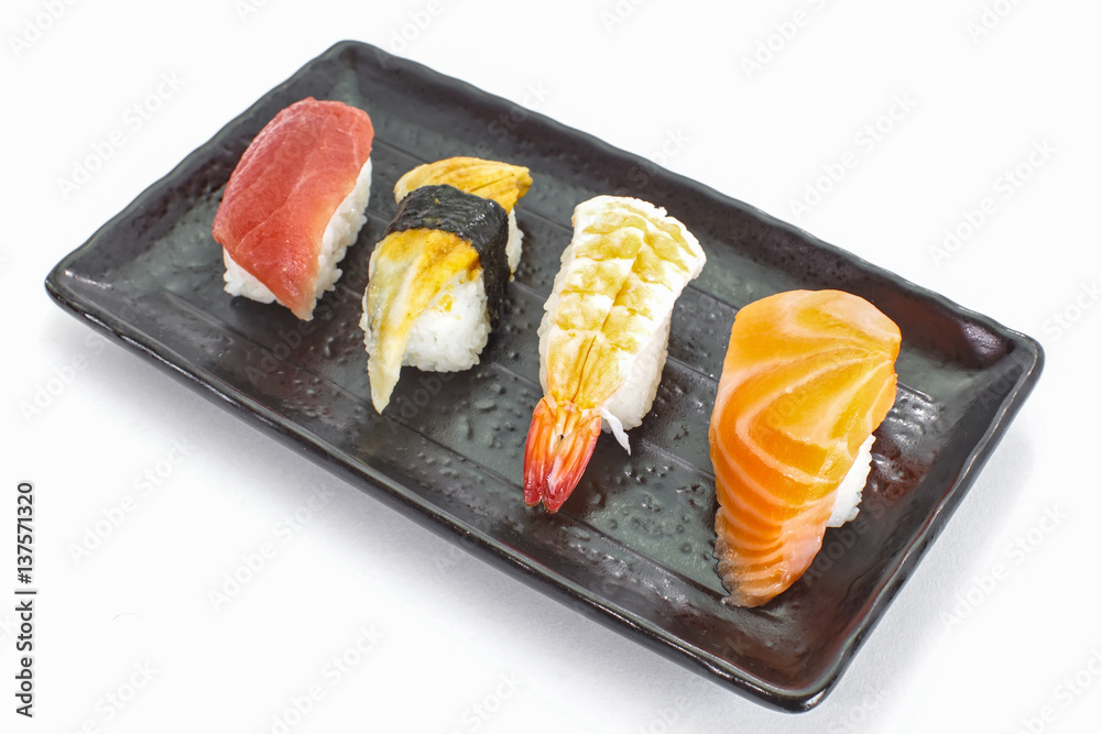 Japanese sushi raw seafood, vegetables and serving of cooked vinegared rice on white table backgroun