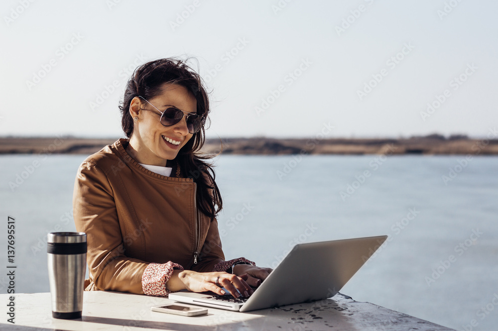 Portrait of young attractive businesswoman working outdoors