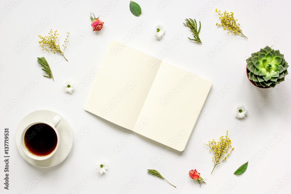 Notebook with cup of coffee on white background top view mockup