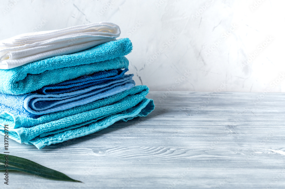 Towels pile in housekeeping set on laudry background mock-up