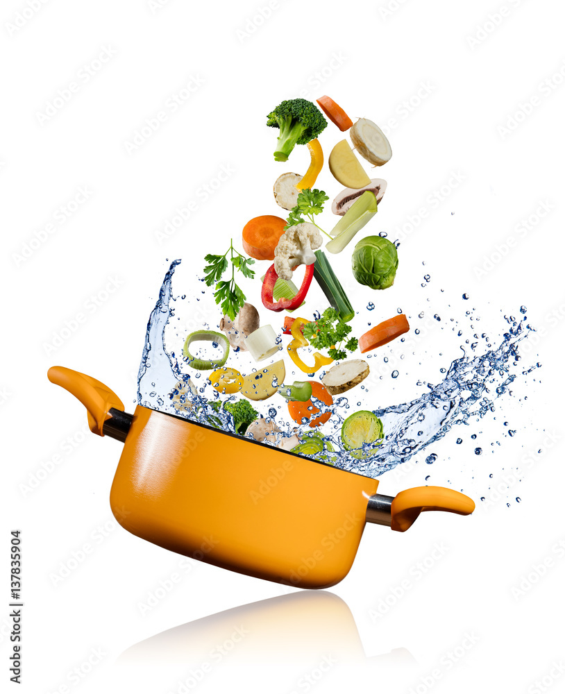 Fresh vegetables flying into a pot on white background